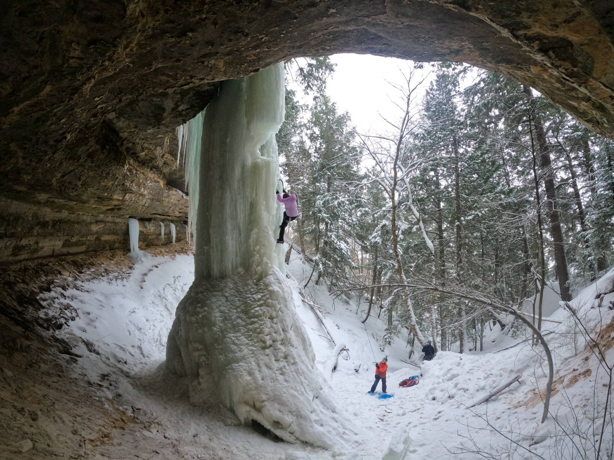 student climbing 50 foot ice pillar at pictured rocks national lakeshore